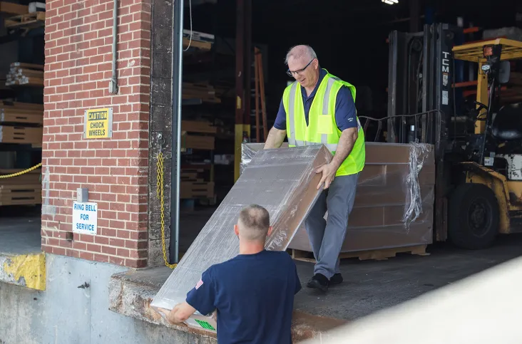 Kamco employee delivering package